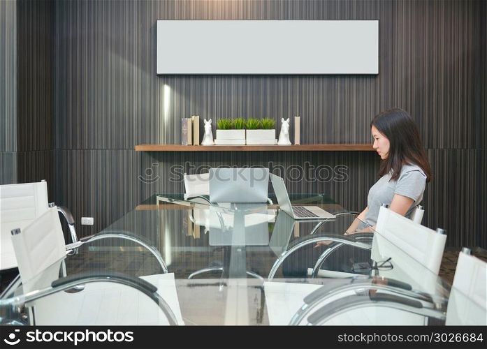 An Asian girl in meeting room in business concept with blank pic. An Asian girl in meeting room in business concept with blank picture. An Asian girl in meeting room in business concept with blank picture