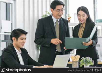 An asian group of business people meeting and planning their project in office