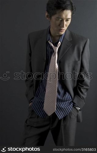 An asian male model wears smart formal fashionable clothes