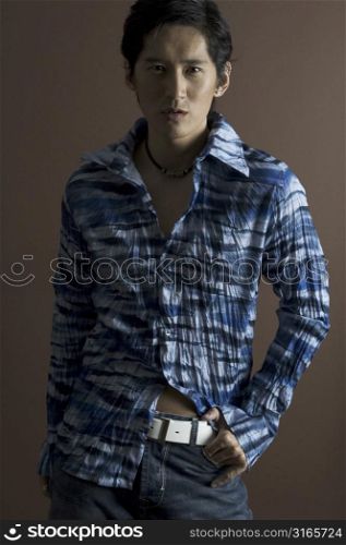 An asian male models in a fashionable crumpled shirt