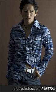 An asian male models in a fashionable crumpled shirt