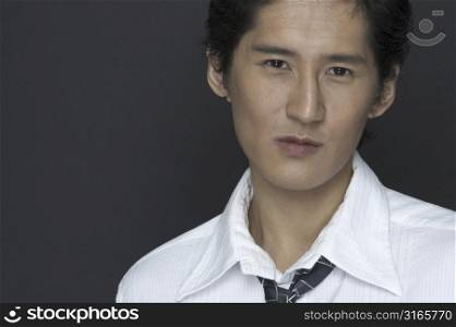 An asian model in a white shirt and tie