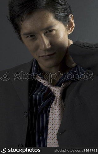 An asian model in smart casual clothing looks at the camera