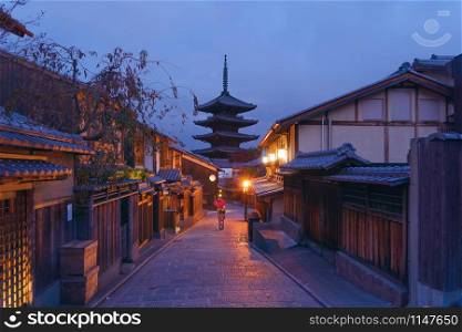 An Asian woman wearing Japanese traditional kimono standing in Yasaka Pagoda Temple during travel holidays vacation trip outdoors in Kyoto City, Japan. Tourist attraction.