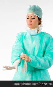 an assistant putting on her gloves before the operation