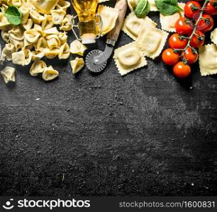 An assortment of different types of traditional raw paste. On black rustic background. An assortment of different types of traditional raw paste.