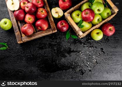An assortment of red and green apples on the table. On a black background. High quality photo. An assortment of red and green apples on the table.