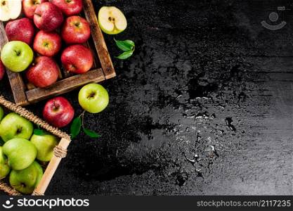 An assortment of red and green apples on the table. On a black background. High quality photo. An assortment of red and green apples on the table.