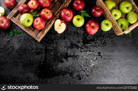 An assortment of red and green apples on the table. On a black background. High quality photo. An assortment of red and green apples on the table.