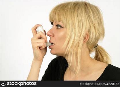 An asthma sufferer using an inhaler.
