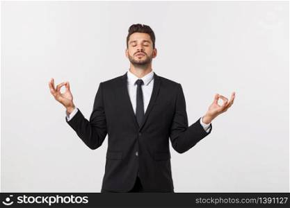 An attractive athletic businessman doing a yoga pose against white background. An attractive athletic businessman doing a yoga pose against white background.
