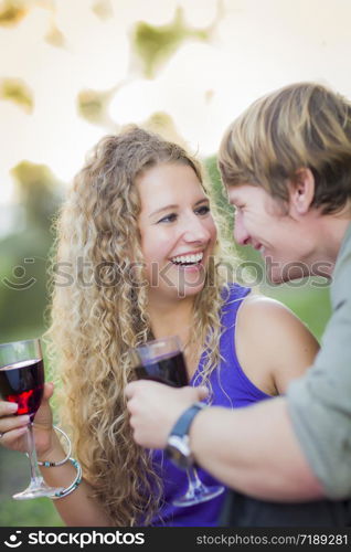 An Attractive Couple Enjoying A Glass Of Wine in the Park Together.