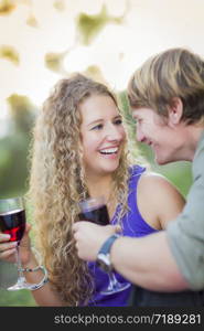 An Attractive Couple Enjoying A Glass Of Wine in the Park Together.