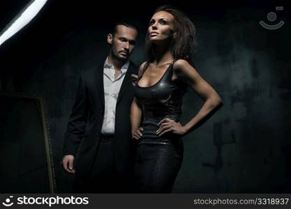 An attractive couple on the dark background