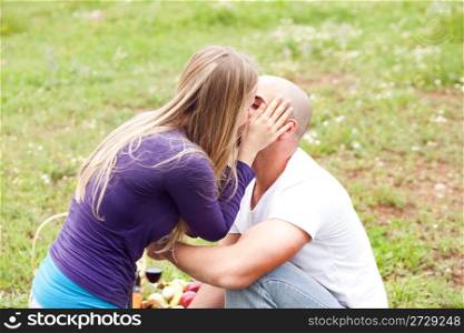 An attractive couple sharing a passionate kiss, outdoors