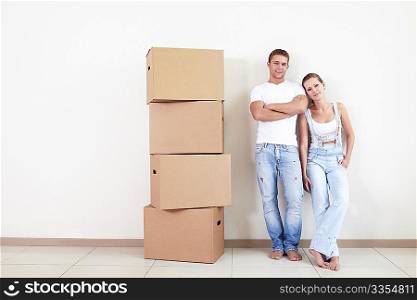 An attractive couple with boxes in new home