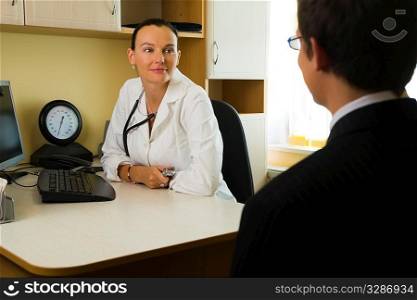 An attractive female doctor listening to a male patient