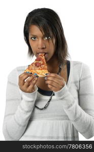 An attractive female eating a slice of pepperoni pizza.