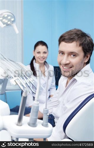 An attractive man at a reception at the dentist