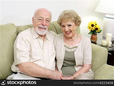 An attractive senior couple relaxing on the couch together.