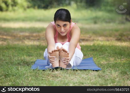 An attractive woman stretching in lawn