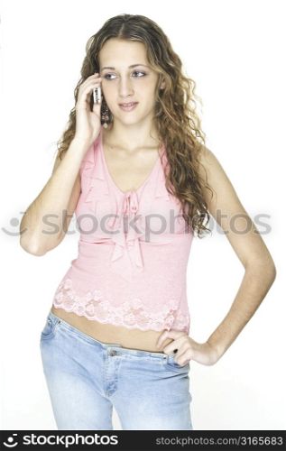 An attractive young female talks on a cellphone