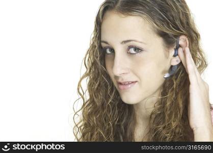 An attractive young model wearing a wireless bluetooth headset