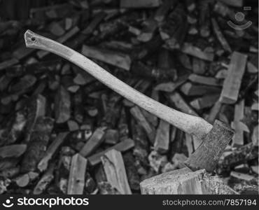 An axe and the woodpile, black and white image