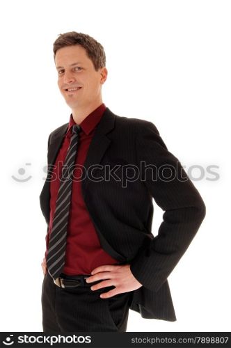 An business man in a suit and tie standing, with his hands on his hips,isolated for white background.