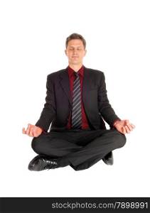 An business man in a suit sitting on the floor, glossing his eye&rsquo;sin a yoga pose, isolated on white background.