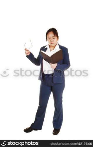 An business woman from Asia standing with a book and her glasses in her handher hand in the studio, for white background.