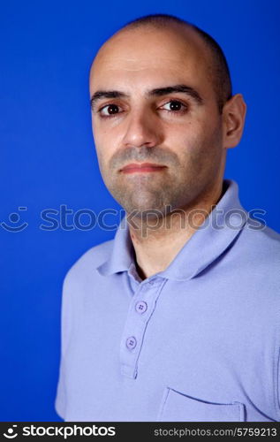 an casual young man portrait over a blue background