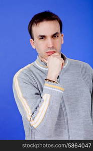 an casual young man portrait over a blue background