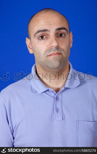 an casual young man portrait over a blue background