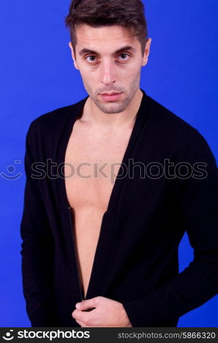 an casual young man portrait over a blue background