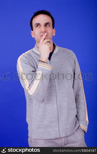 an casual young man portrait over a blue background