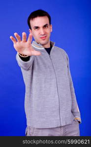 an casual young man portrait over a blue background