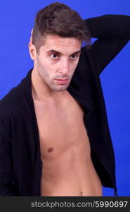 an casual young man portrait over a blue background