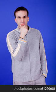 an casual young man portrait over a blue background