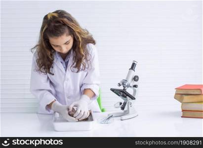 An caucasian white teen girl or student studying frog surgery, science and experiment in classroom at school. Education Concept.