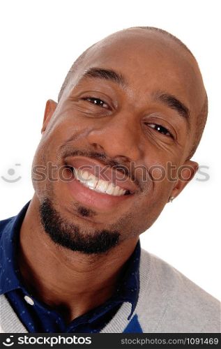An close up portrait image of an African American man smiling bald and with a small beard, isolated for white background