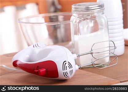 an egg beater and sugar in a kitchen