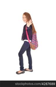 An eight year schoolgirl with her backpack over her shoulder standing forwhite background, waiving good by.