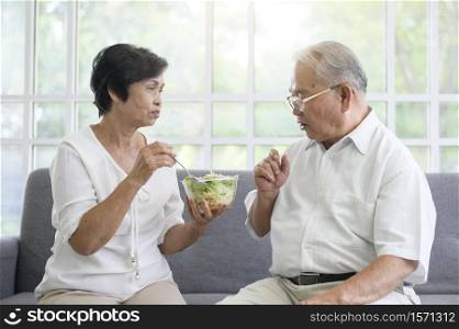 An elderly couple are eating healthy food , grandparents health care concept .. An elderly couple are eating healthy food , grandparents health care concept