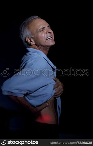 An elderly man suffering from backache