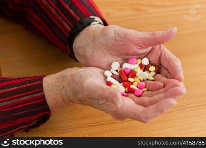 an elderly patient with pills and medication in hand
