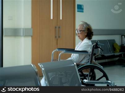 An elderly woman sits in a wheelchair after undergoing treatment for depression. Waiting for relatives to come back home with hope