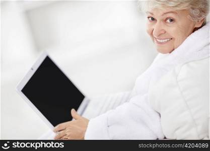 An elderly woman with a laptop