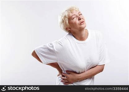 An elderly woman with a sick back on a white background