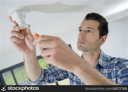 an electrician fixing exposed wiring